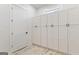 Storage area featuring white cabinets and hardwood-style flooring at 1230 Hayes Sq, Peachtree City, GA 30269