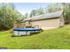 Spacious backyard featuring a deck and above ground pool at 575 Chuli Rd, Locust Grove, GA 30248
