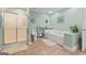 A full bathroom featuring a shower, a bathtub, tile flooring, and light green colored walls at 575 Chuli Rd, Locust Grove, GA 30248