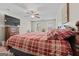 Bedroom featuring carpet flooring, a ceiling fan, and two windows allowing for plenty of natural light at 575 Chuli Rd, Locust Grove, GA 30248