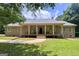 Charming home featuring a welcoming front porch with decorative columns and a well-maintained lawn at 575 Chuli Rd, Locust Grove, GA 30248