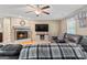 Comfortable living room showcasing a fireplace, mounted TV, and plush leather seating at 575 Chuli Rd, Locust Grove, GA 30248