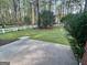 Scenic backyard view showcasing a well-maintained lawn and mature trees at 116 Glendale Dr, Peachtree City, GA 30269