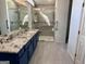 Bathroom featuring double sinks, modern shower, and grey tiled floors at 116 Glendale Dr, Peachtree City, GA 30269