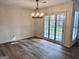 Bright dining room with stylish chandelier and patio doors leading to the backyard at 116 Glendale Dr, Peachtree City, GA 30269