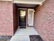 Close-up of the brick entryway showcasing the front door, sidelight window, and classic brick facade at 116 Glendale Dr, Peachtree City, GA 30269