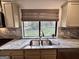Kitchen sink with a view to the outside and granite countertops at 116 Glendale Dr, Peachtree City, GA 30269