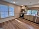 Well-lit kitchen featuring wood floors, modern appliances, and granite countertops with view to outside at 116 Glendale Dr, Peachtree City, GA 30269