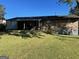 View of the backyard with a covered patio and well-maintained lawn at 266 Ridge Trl, Riverdale, GA 30274