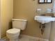 Modest bathroom featuring a vintage toilet, sink and vanity with wall-mounted fixtures at 266 Ridge Trl, Riverdale, GA 30274