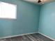 This bedroom features a ceiling fan, a large window, and sleek gray wood flooring at 266 Ridge Trl, Riverdale, GA 30274