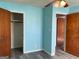 This bedroom has light blue walls and wood flooring with door leading to closet and hallway at 266 Ridge Trl, Riverdale, GA 30274
