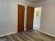 Spacious bedroom featuring a closet, an open doorway, and new flooring at 266 Ridge Trl, Riverdale, GA 30274