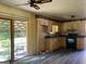 Functional kitchen with wood cabinets, black appliances, and a sliding door to the patio at 266 Ridge Trl, Riverdale, GA 30274