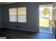 Bright living room with large window, an open doorway, and modern gray flooring at 266 Ridge Trl, Riverdale, GA 30274