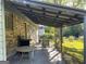 Covered outdoor patio with tables, chairs, and a grill, perfect for outdoor dining and entertaining at 266 Ridge Trl, Riverdale, GA 30274