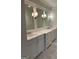 Bright bathroom featuring double sinks, marble countertops, and sleek cabinets offering a modern and luxurious space at 813 Creekgarden Court, Atlanta, GA 30339