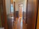 A well-lit hallway with hardwood floors and paneled walls that connects various rooms at 6099 Winview Dr, Forest Park, GA 30297