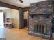 Inviting living room featuring a brick fireplace, hardwood floors, and paneled walls at 6099 Winview Dr, Forest Park, GA 30297