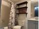 Nicely designed bathroom with shelves, gray vanity, updated lighting, tile flooring and a shower/tub combo at 6332 Valley Dale Dr, Riverdale, GA 30274