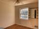 Bedroom featuring hardwood floors, a window, built-in shelves, and a ceiling fan at 6332 Valley Dale Dr, Riverdale, GA 30274