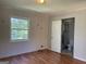 Bedroom with hardwood floors, a window, and an attached bathroom at 6332 Valley Dale Dr, Riverdale, GA 30274