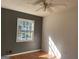 Bright bedroom with two-tone walls, hardwood floors, a ceiling fan, and a sun-filled window at 6332 Valley Dale Dr, Riverdale, GA 30274