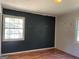 Bedroom with two-tone walls, hardwood floors, and a window at 6332 Valley Dale Dr, Riverdale, GA 30274