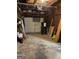 A look at the garage with a white garage door, concrete floor, storage shelves, and garage door opening system at 6332 Valley Dale Dr, Riverdale, GA 30274