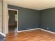 Living room featuring hardwood floors, neutral walls, and a glimpse into the adjacent room at 6332 Valley Dale Dr, Riverdale, GA 30274