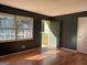 Living room with natural light, hardwood floors, and a view of the front yard through a large window at 6332 Valley Dale Dr, Riverdale, GA 30274