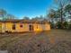 Back exterior view of home featuring sliding glass doors and large yard at 117 Old Stagecoach Rd, Carrollton, GA 30116