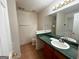 Bathroom featuring a vanity with green countertop, large mirror, and tile flooring at 117 Old Stagecoach Rd, Carrollton, GA 30116