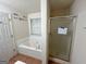 Bathroom featuring a garden tub, stand-up shower with glass doors, and tile flooring at 117 Old Stagecoach Rd, Carrollton, GA 30116