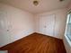 Bedroom featuring a closet, window with view, and wood flooring at 117 Old Stagecoach Rd, Carrollton, GA 30116