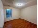 Bedroom featuring a window with view and wood flooring at 117 Old Stagecoach Rd, Carrollton, GA 30116