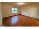 Spacious bedroom featuring a large window and gleaming hardwood floors at 117 Old Stagecoach Rd, Carrollton, GA 30116