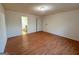 Spacious bedroom featuring gleaming hardwood floors, a ceiling light, and bathroom access at 117 Old Stagecoach Rd, Carrollton, GA 30116