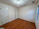 Bedroom featuring wood floor, ceiling light, window, and two doors at 117 Old Stagecoach Rd, Carrollton, GA 30116