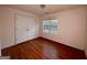 Bedroom featuring a closet, window with view, and wood flooring at 117 Old Stagecoach Rd, Carrollton, GA 30116