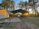 Spacious carport with a concrete pad and additional storage shed at 117 Old Stagecoach Rd, Carrollton, GA 30116