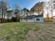 Single-story home nestled among mature trees, featuring a carport at 117 Old Stagecoach Rd, Carrollton, GA 30116