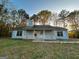 Charming single-story home with a covered front porch and large front yard surrounded by mature trees at 117 Old Stagecoach Rd, Carrollton, GA 30116