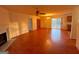 Open-concept living room flows into dining area, featuring hardwood floors, a fireplace and natural light at 117 Old Stagecoach Rd, Carrollton, GA 30116