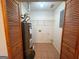 This utility room features a water heater, wire shelving, and tiled floor behind folding doors at 117 Old Stagecoach Rd, Carrollton, GA 30116