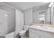 Bathroom featuring a single vanity, tub with shower, and view of the upstairs hallway at 4654 Liberty Square Dr, Acworth, GA 30101
