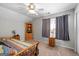 Bedroom features neutral gray walls, wood furniture, ceiling fan, and natural light at 4654 Liberty Square Dr, Acworth, GA 30101