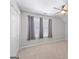 Bright bedroom with natural light, gray curtains, ceiling fan, double closet, and neutral carpet at 4654 Liberty Square Dr, Acworth, GA 30101