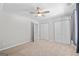 Spacious bedroom with double closets, plush carpet, ceiling fan, and neutral gray walls at 4654 Liberty Square Dr, Acworth, GA 30101