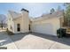 View of the home featuring a spacious driveway and attached two-car garage at 4654 Liberty Square Dr, Acworth, GA 30101